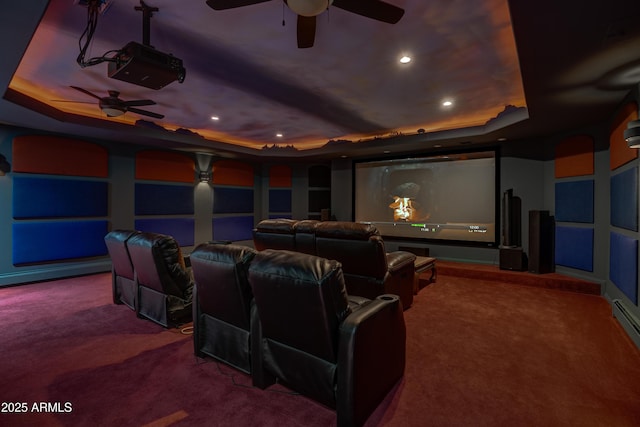 carpeted home theater room with recessed lighting and a tray ceiling