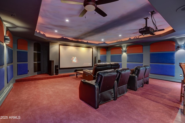 home theater room featuring recessed lighting, a raised ceiling, carpet, and baseboard heating