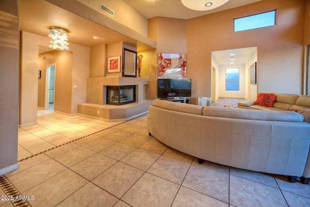 living room featuring light tile patterned flooring and a multi sided fireplace