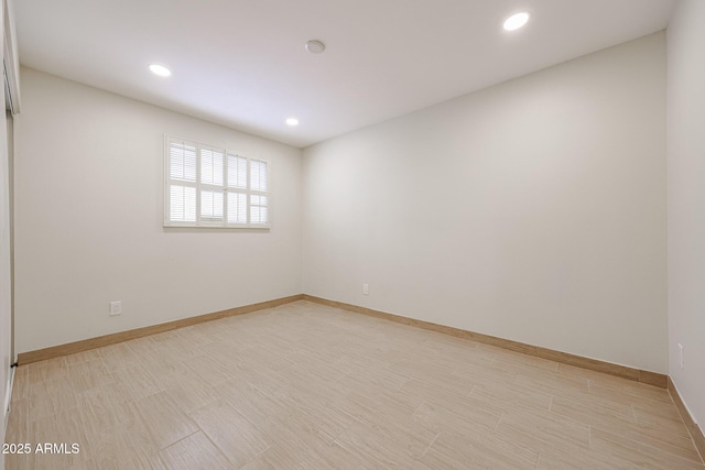 spare room with light wood-style floors, recessed lighting, and baseboards