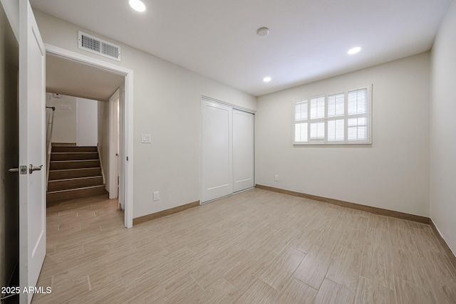 unfurnished bedroom with light wood-style flooring, recessed lighting, visible vents, baseboards, and a closet