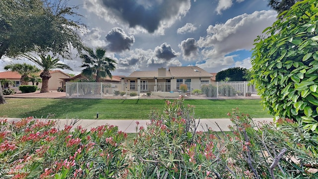 rear view of house featuring a yard