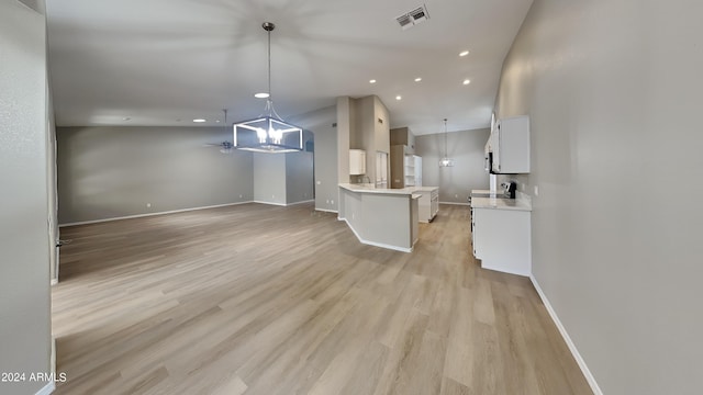 kitchen featuring white cabinetry, ceiling fan, decorative light fixtures, and light wood-type flooring