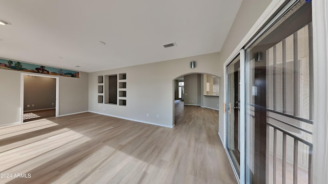 unfurnished living room with light hardwood / wood-style flooring