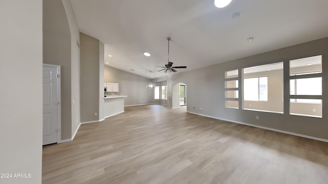 unfurnished living room with light wood-type flooring, ceiling fan, and lofted ceiling