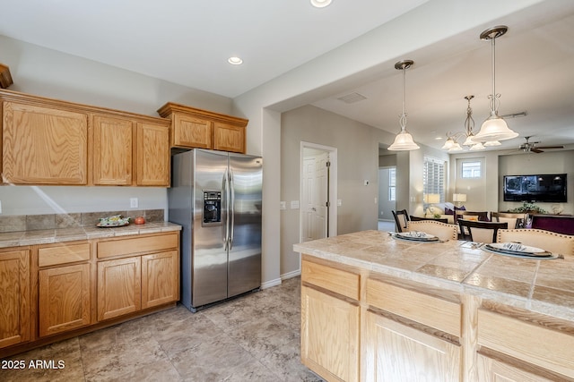 kitchen with pendant lighting and stainless steel fridge