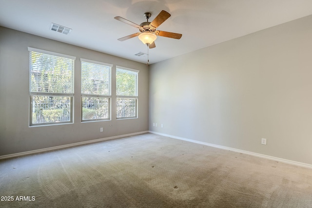 carpeted spare room with ceiling fan