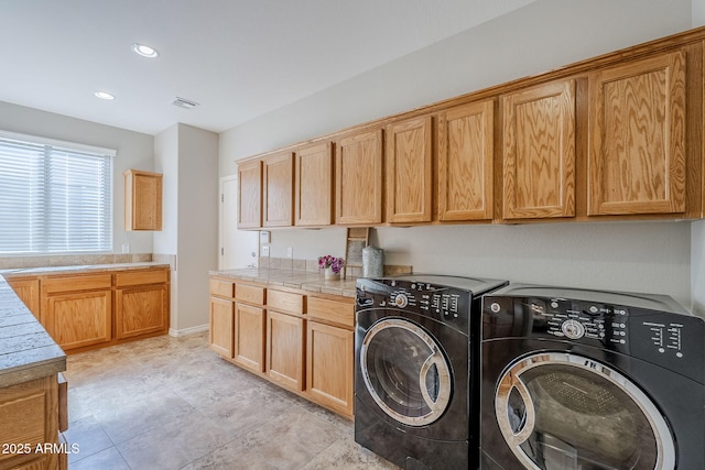 laundry area featuring cabinets and independent washer and dryer