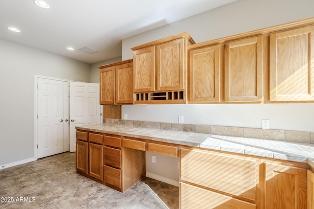 kitchen with built in desk and tile countertops