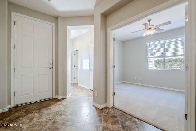 carpeted entryway with ceiling fan