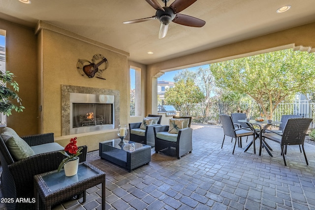 view of patio featuring a grill, a high end fireplace, and ceiling fan