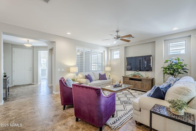 living room with ceiling fan and a healthy amount of sunlight