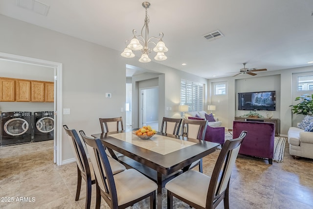 dining room featuring ceiling fan with notable chandelier and washer and clothes dryer