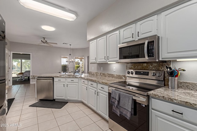 2714 N 63rd St, Mesa, AZ 85215 - kitchen with white cabinetry, appliances with stainless steel finishes, decorative light fixtures, and sink