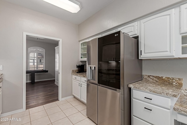 2714 N 63rd St, Mesa, AZ 85215 - kitchen featuring stainless steel fridge, light stone countertops, white cabinets, and light tile patterned flooring