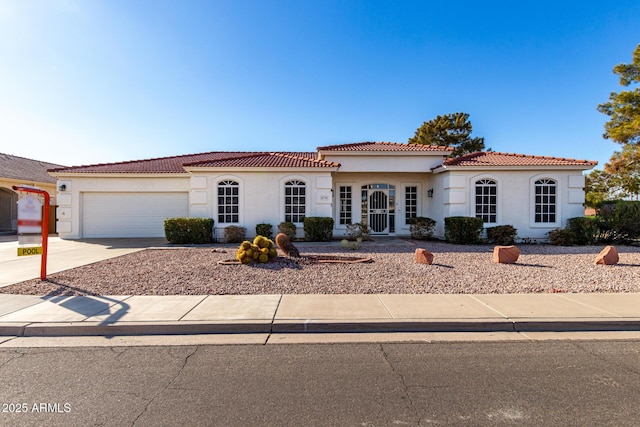 2714 N 63rd St, Mesa, AZ 85215 - mediterranean / spanish house featuring a garage