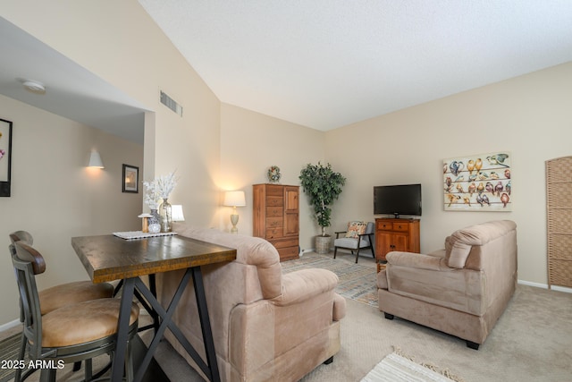 living area featuring light carpet, visible vents, lofted ceiling, and baseboards