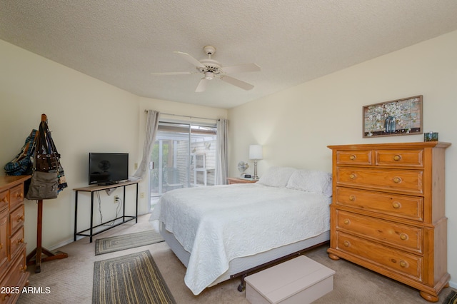 carpeted bedroom featuring a textured ceiling, ceiling fan, and access to outside