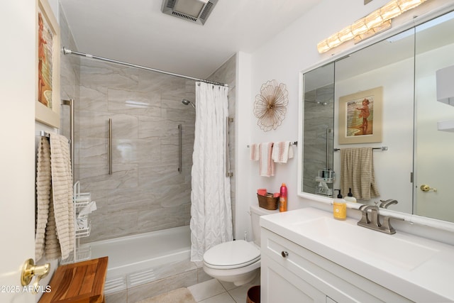 full bathroom with visible vents, toilet, a tile shower, tile patterned flooring, and vanity