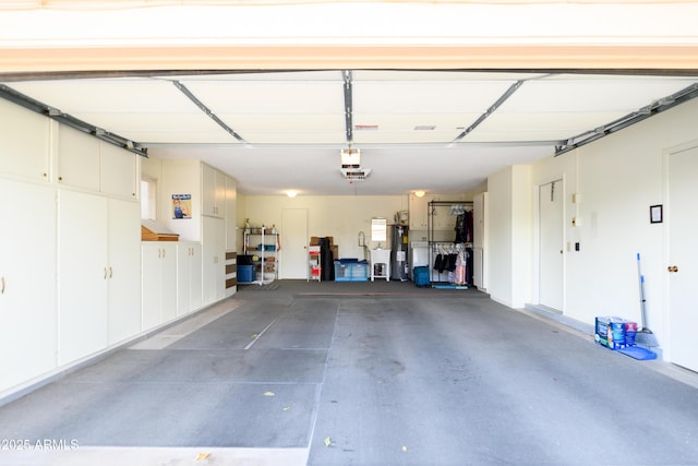 garage with a garage door opener and water heater