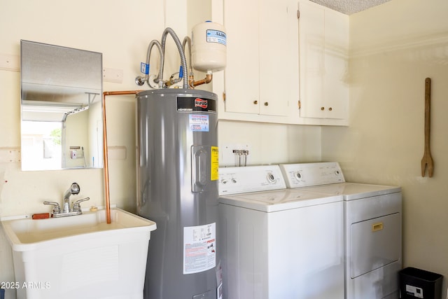 washroom with a sink, cabinet space, washing machine and dryer, and water heater