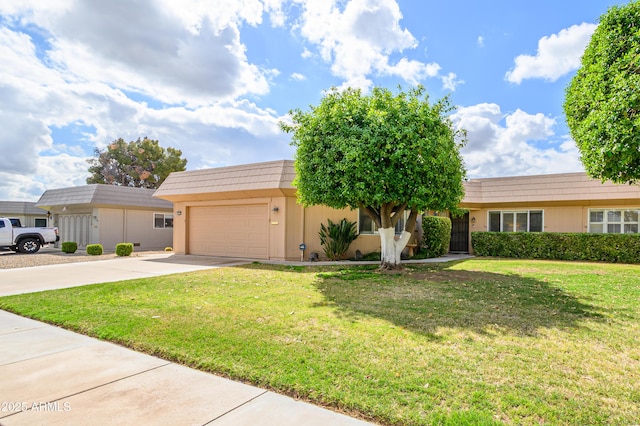 view of front facade featuring driveway, a front lawn, and an attached garage