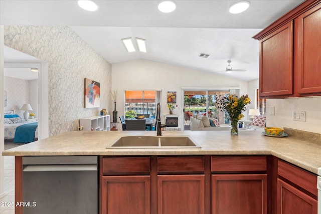 kitchen with visible vents, open floor plan, a peninsula, light countertops, and a sink