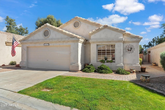 view of front facade with driveway, stucco siding, a tile roof, an attached garage, and a front yard