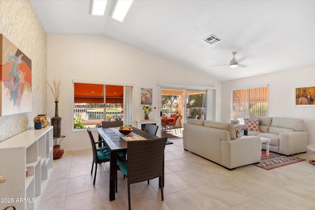 dining area featuring vaulted ceiling, light tile patterned floors, plenty of natural light, and visible vents