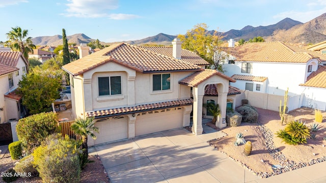 mediterranean / spanish-style house featuring a mountain view and a garage