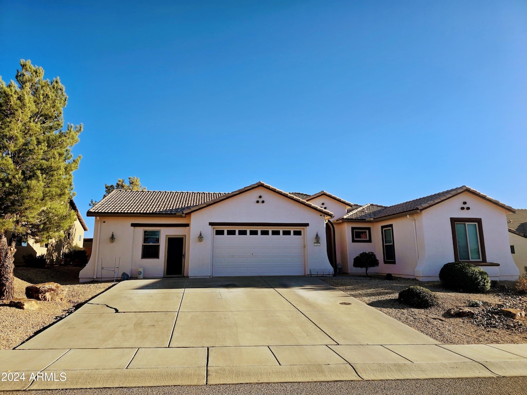 mediterranean / spanish home featuring a garage