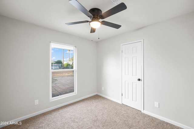 carpeted empty room featuring ceiling fan