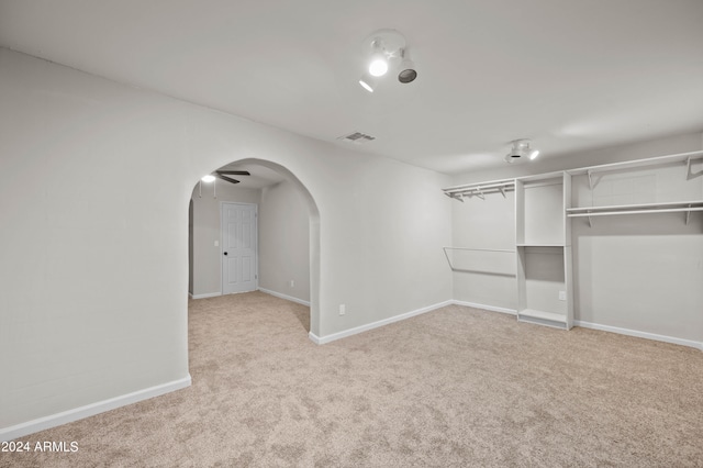 carpeted spare room with ceiling fan