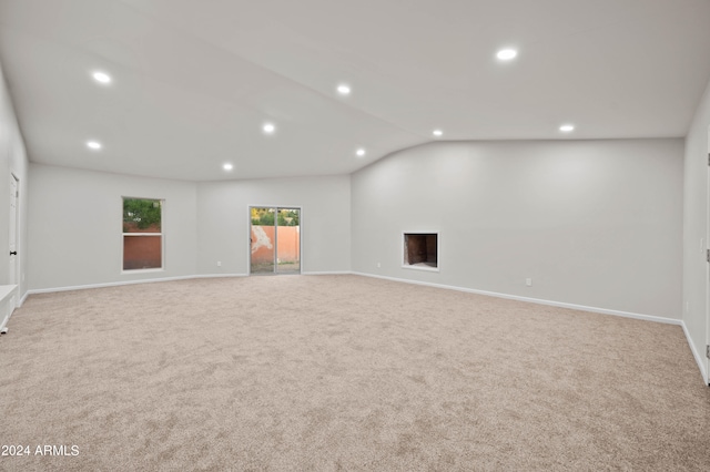 basement with light carpet and a fireplace