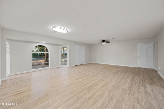 unfurnished living room with ceiling fan and light wood-type flooring