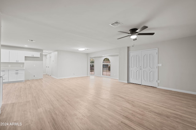 unfurnished living room featuring ceiling fan and light hardwood / wood-style floors