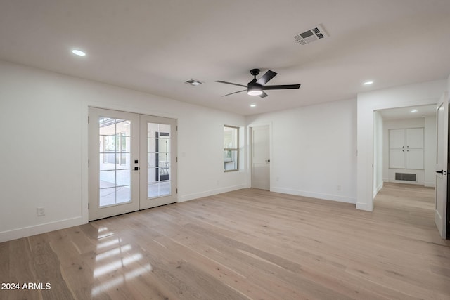 unfurnished room with ceiling fan, french doors, and light wood-type flooring