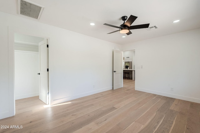 unfurnished room featuring ceiling fan and light wood-type flooring