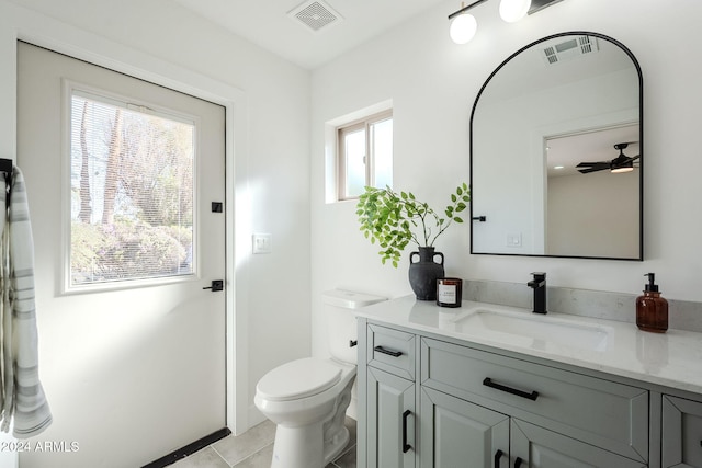 bathroom featuring vanity, toilet, a wealth of natural light, and ceiling fan