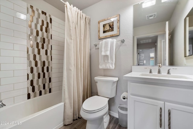 full bathroom featuring hardwood / wood-style floors, vanity, shower / tub combo, and toilet