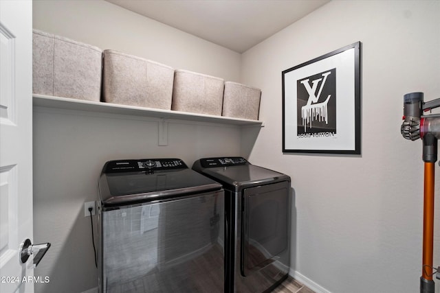 washroom with wood-type flooring and washing machine and clothes dryer