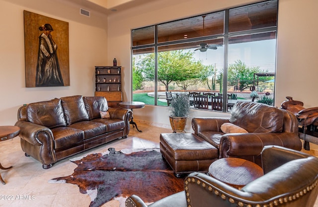 tiled living room featuring ceiling fan