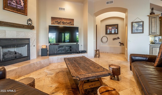 living room featuring a tile fireplace