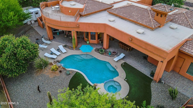 view of swimming pool with a patio area and an in ground hot tub