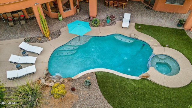 view of swimming pool with an in ground hot tub and a patio area