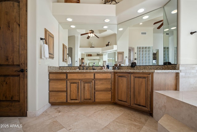 bathroom featuring ceiling fan and vanity