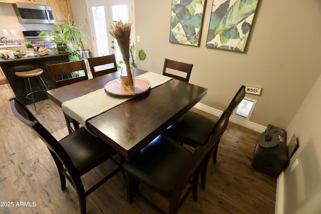 711 W El Alba Way, Chandler, AZ 85225 - dining area with light wood-style flooring and baseboards