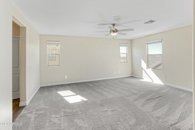 empty room featuring ceiling fan, carpet flooring, and baseboards