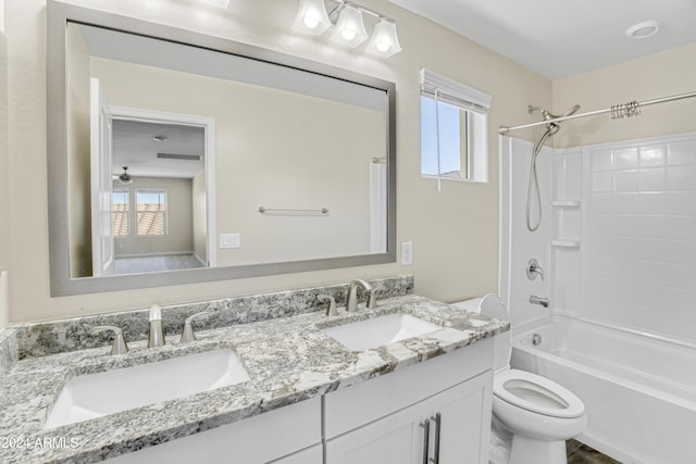 bathroom with toilet, healthy amount of natural light, double vanity, and shower / bathtub combination
