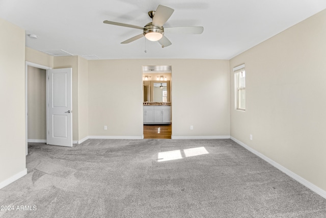 empty room featuring carpet, a ceiling fan, and baseboards
